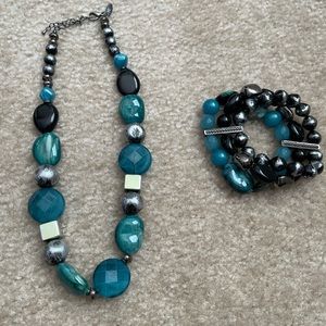 Beaded necklace with stacked bracelets.
